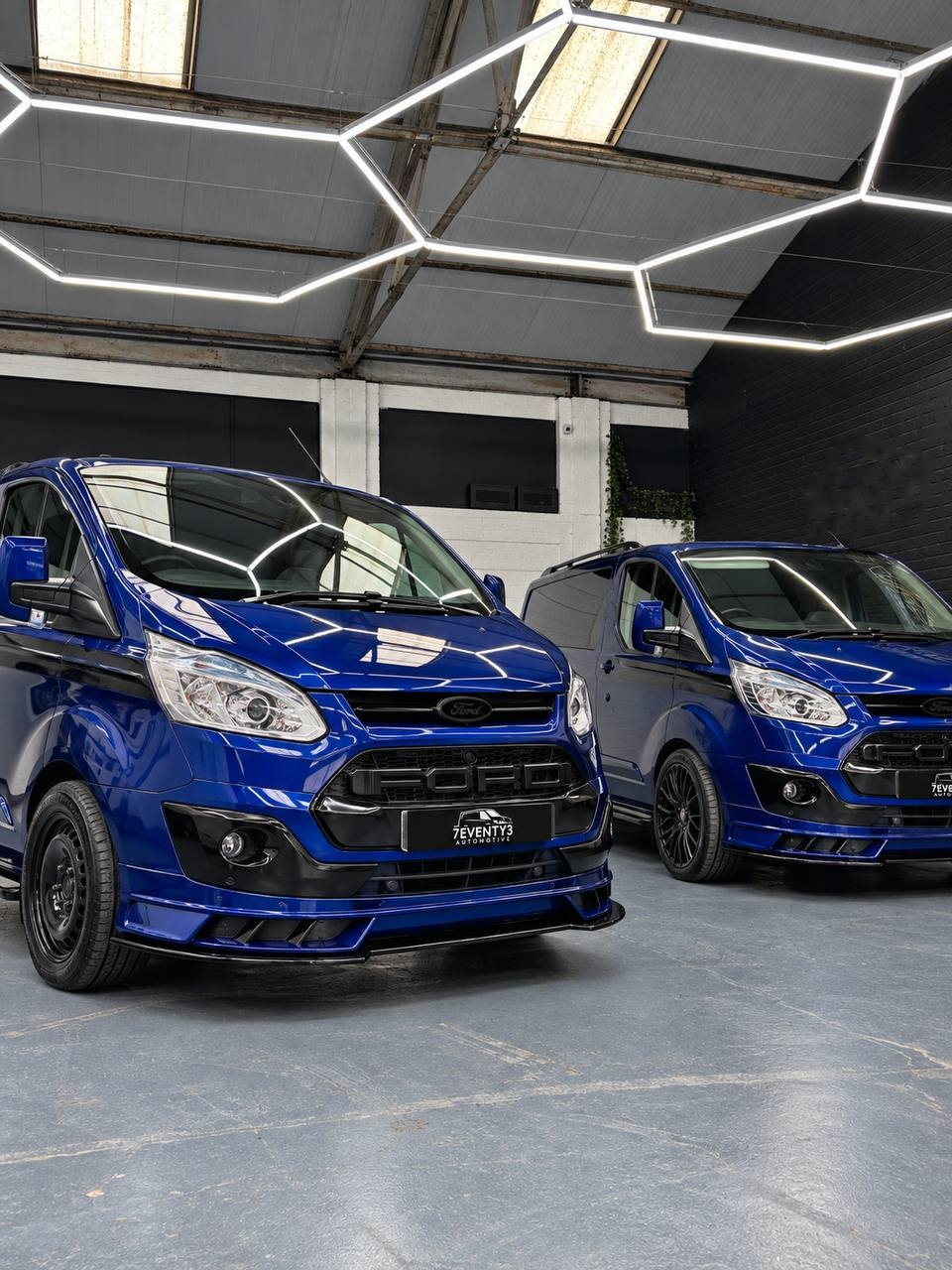 Two blue Seventy3 vans in the Annan showroom